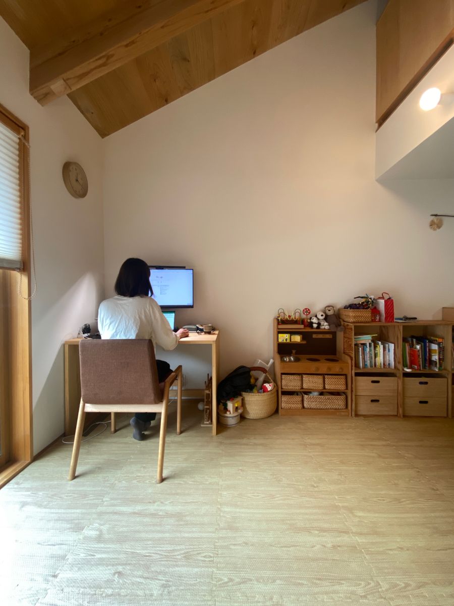 ご主人DIYの木製ワークスペースで作業する奥様